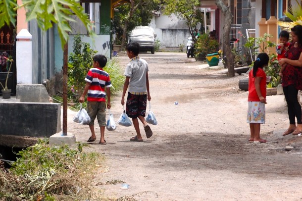 Some kids taking their share of goat and beef home.